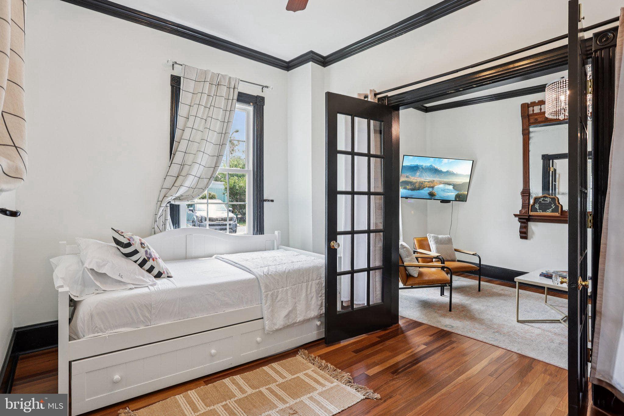 414 Broadway Cape May, NJ 08204 - Photo 30 of 48 a bedroom with a bed and wooden floor