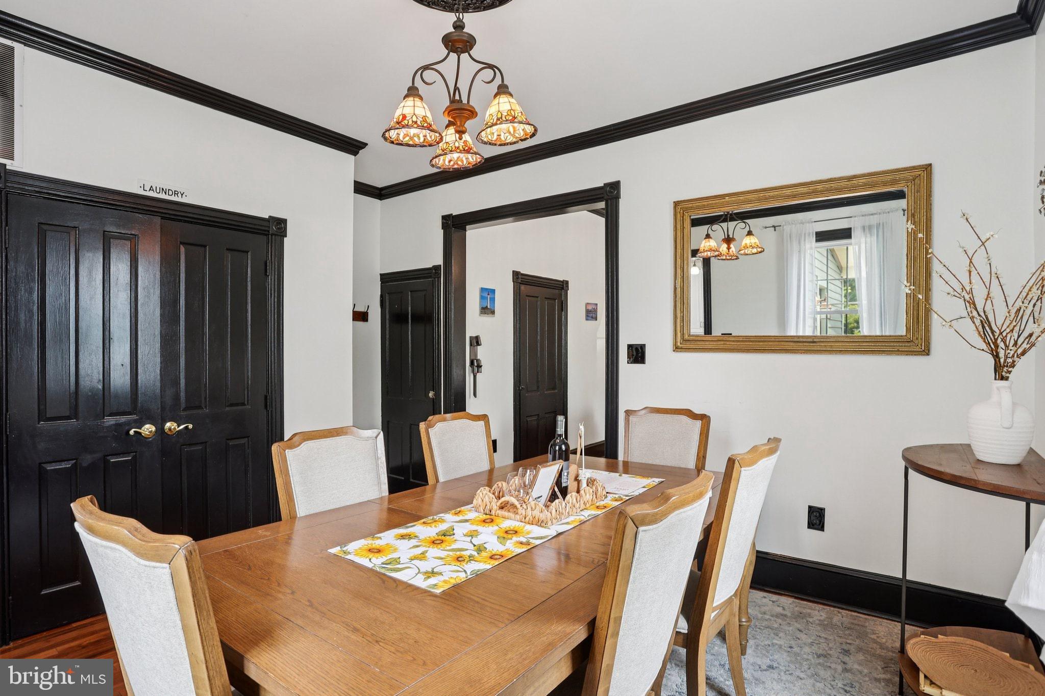414 Broadway Cape May, NJ 08204 - Photo 33 of 48 a dining room with furniture a chandelier and window