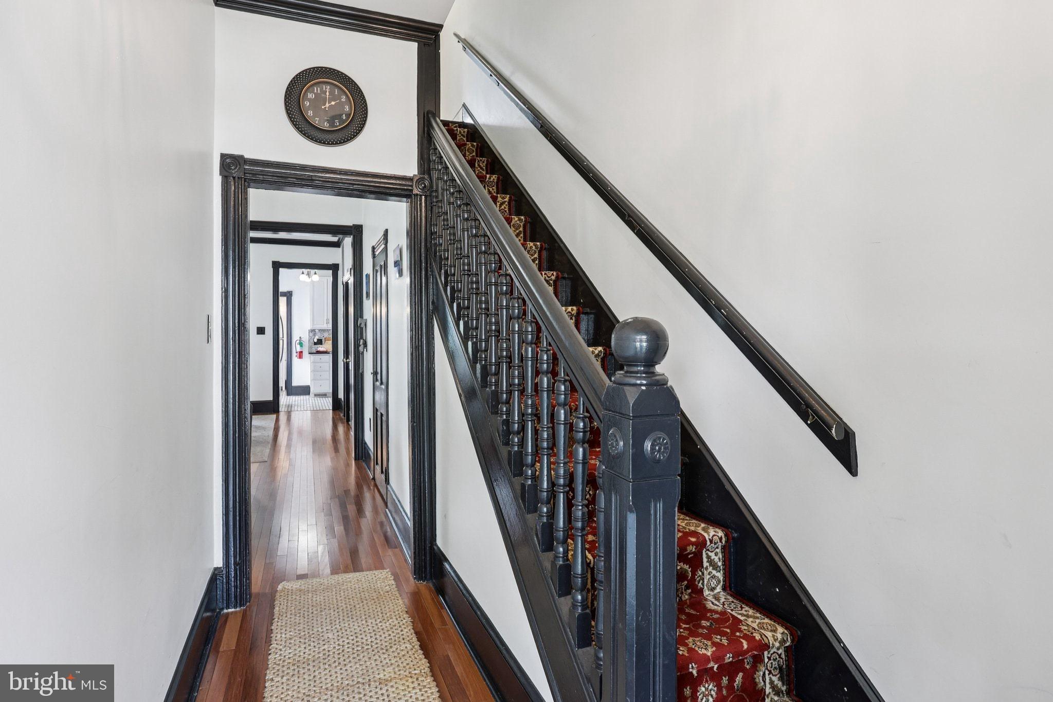 414 Broadway Cape May, NJ 08204 - Photo 40 of 48 a view of a hallway with wooden floor and staircase