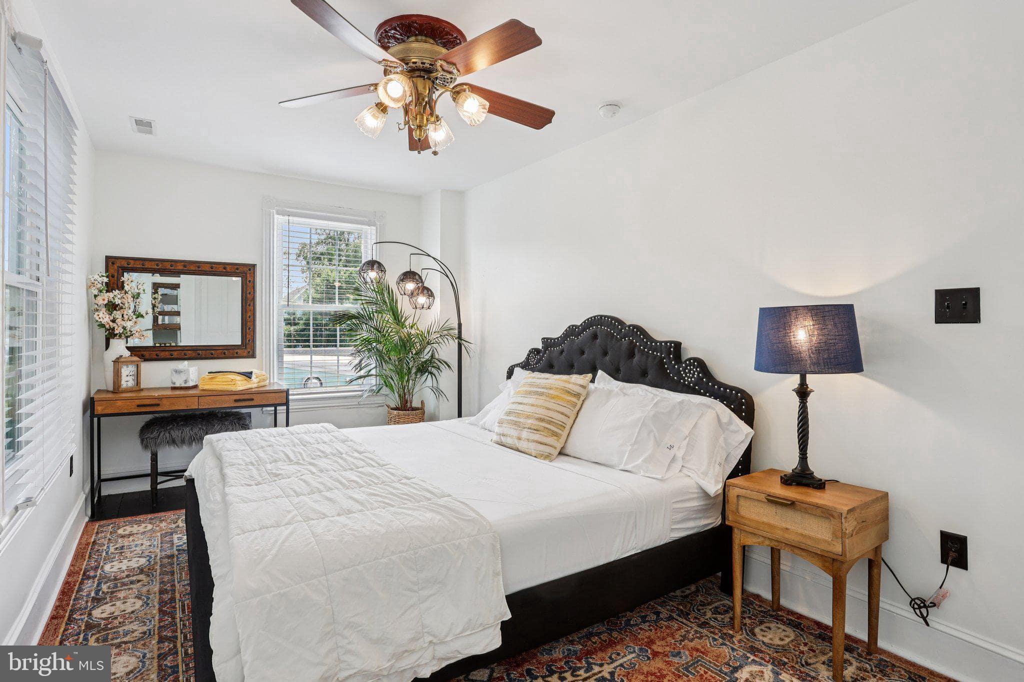 414 Broadway Cape May, NJ 08204 - Photo 42 of 48 a bedroom with a bed a desk and chair