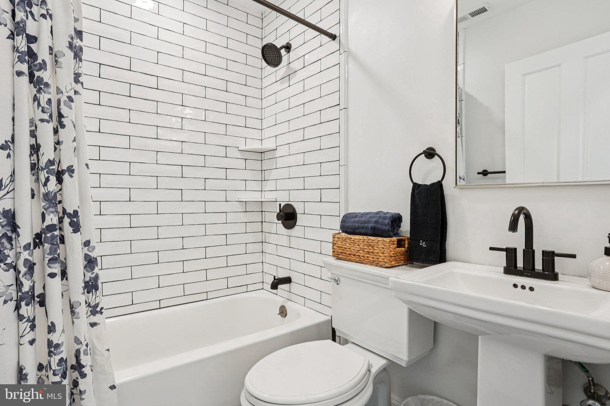 414 Broadway Cape May, NJ 08204 - Photo 44 of 48 a bathroom with a sink toilet and shower