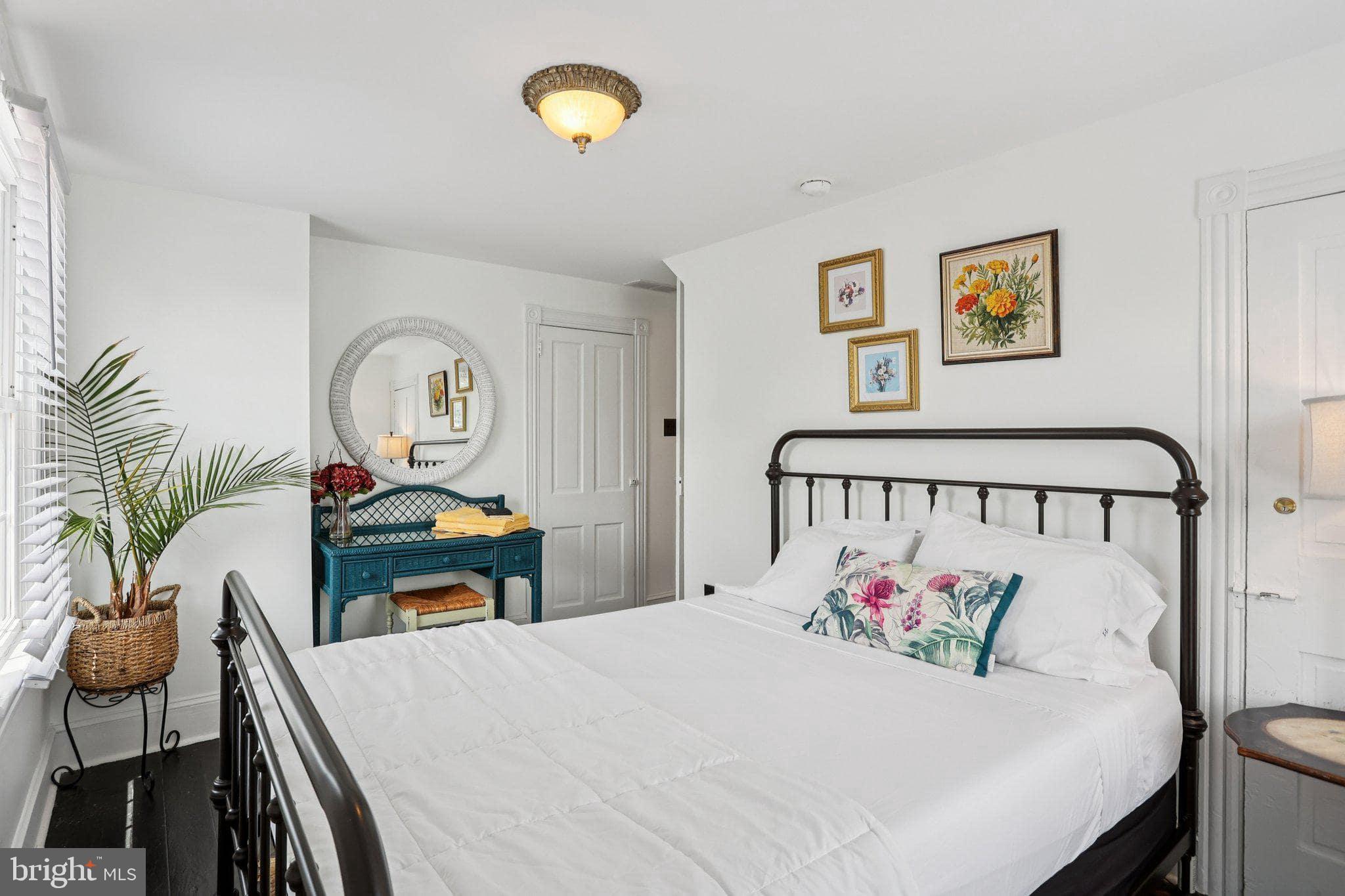 414 Broadway Cape May, NJ 08204 - Photo 46 of 48 a bedroom with a bed and a table