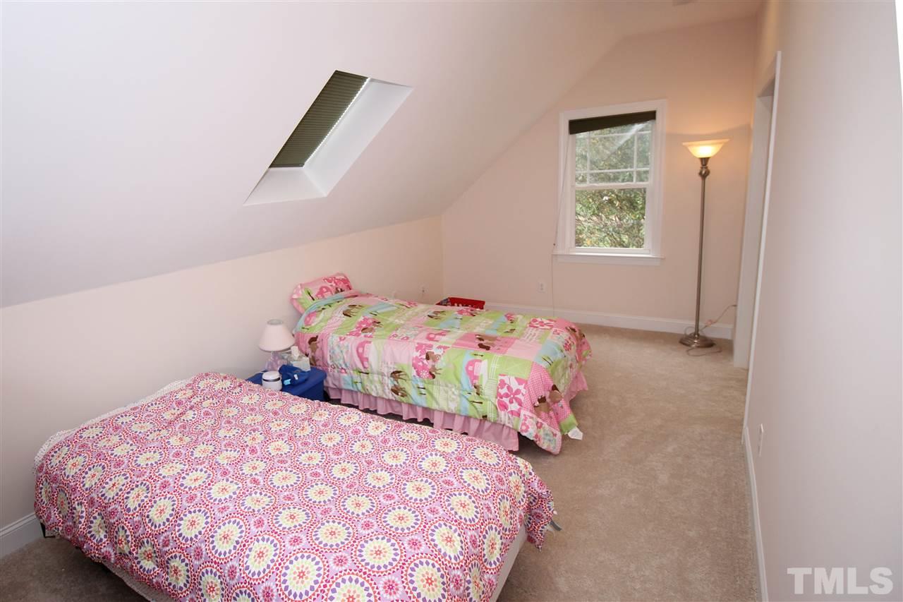 8808 Oregon Inlet Court Raleigh, NC 27603 - Photo 11 of 19 a bedroom with a bed and a window