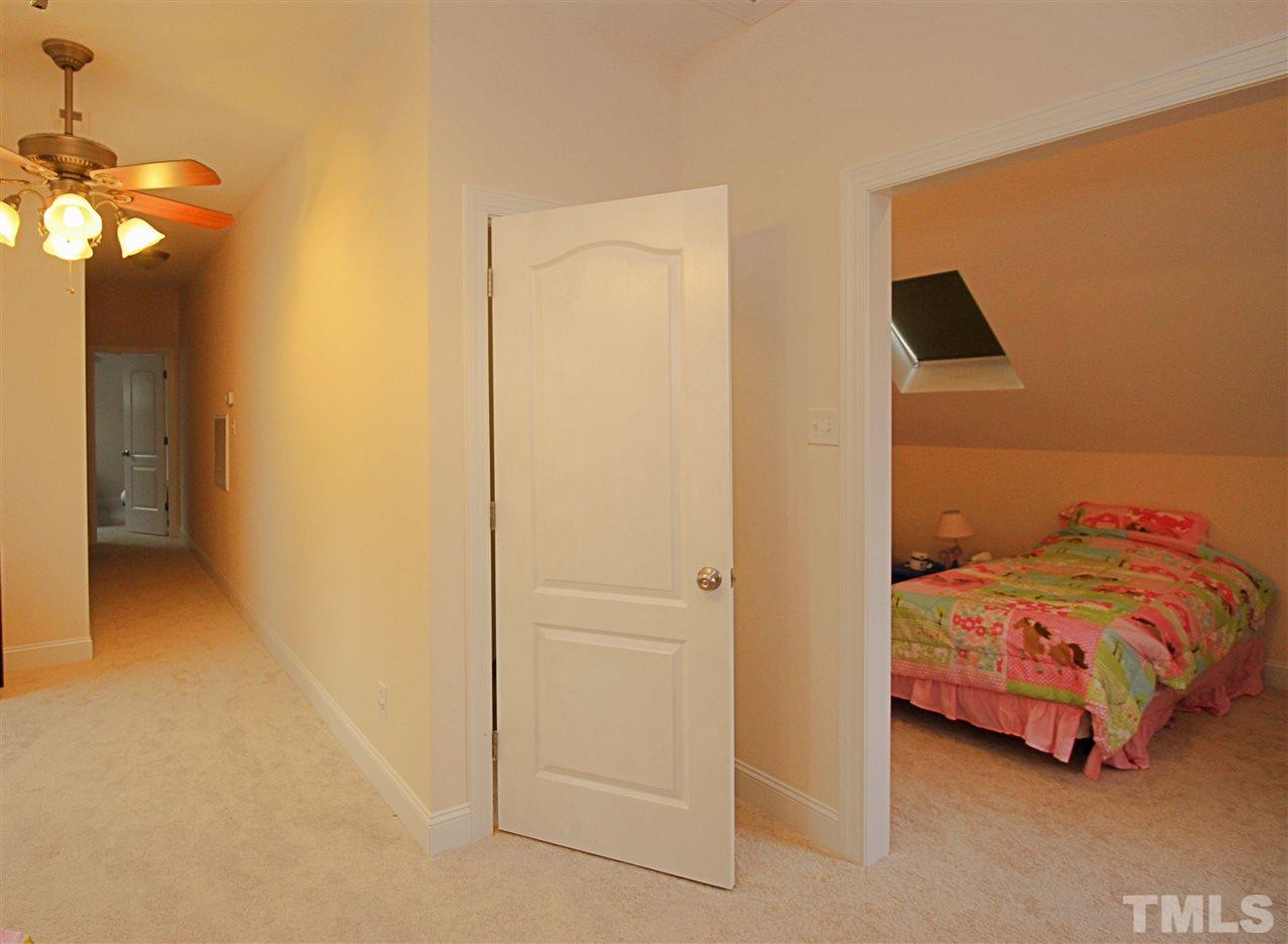 8808 Oregon Inlet Court Raleigh, NC 27603 - Photo 13 of 19 a bedroom with a bed and a cabinets