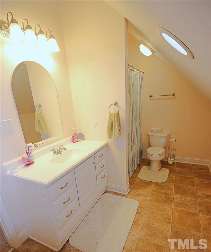 8808 Oregon Inlet Court Raleigh, NC 27603 - Photo 14 of 19 a bathroom with a double vanity sink mirror and toilet
