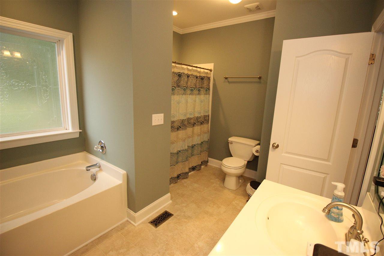 8808 Oregon Inlet Court Raleigh, NC 27603 - Photo 17 of 19 a bathroom with a tub and toilet