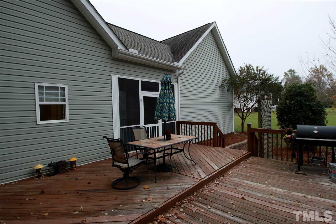 8808 Oregon Inlet Court Raleigh, NC 27603 - Photo 4 of 19 a view of a house with wooden deck and furniture