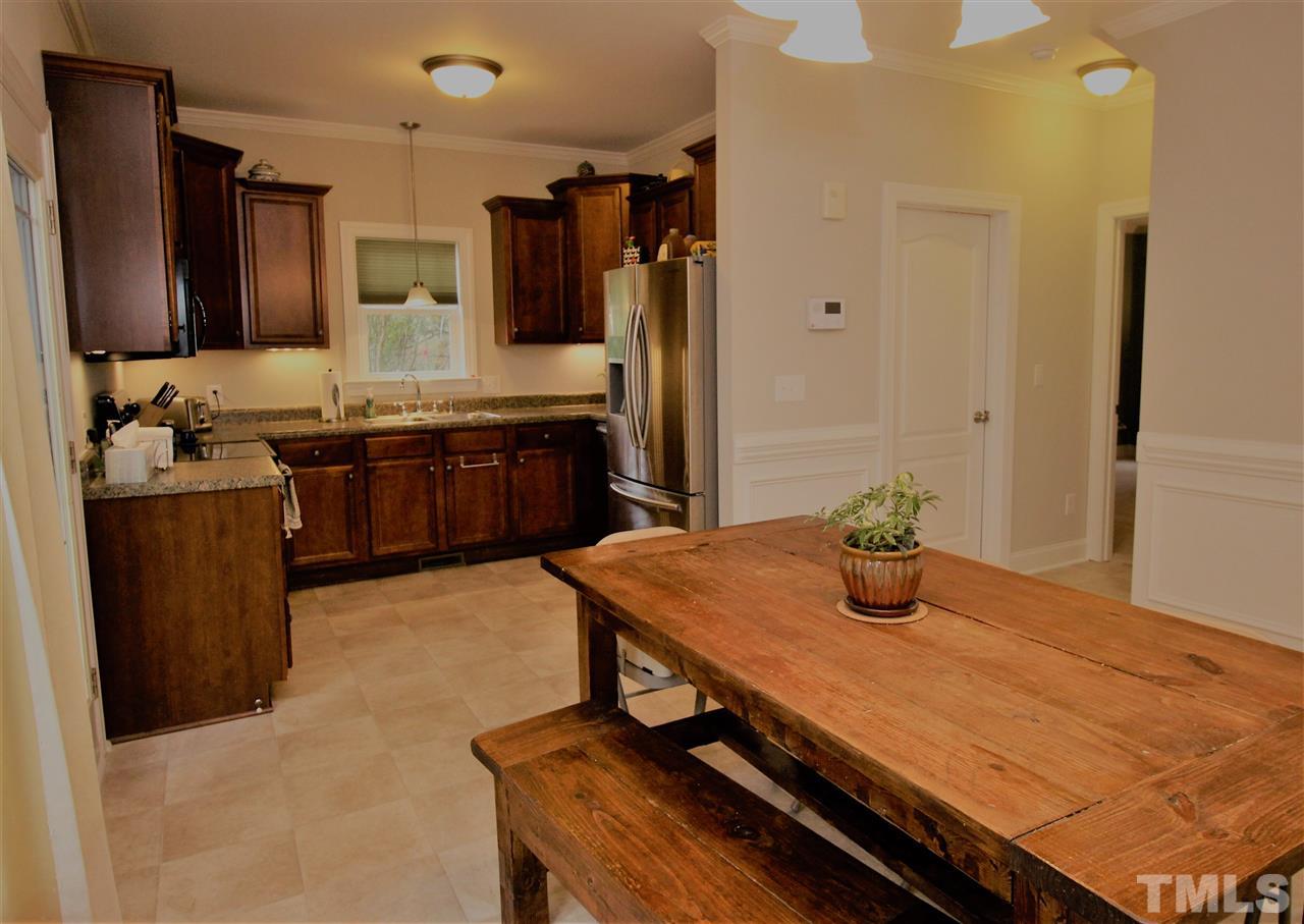 8808 Oregon Inlet Court Raleigh, NC 27603 - Photo 7 of 19 a kitchen with a stove and a refrigerator
