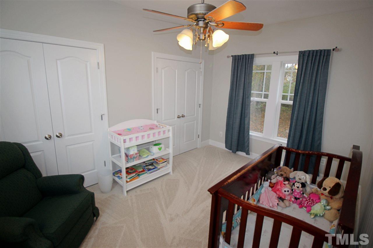 8808 Oregon Inlet Court Raleigh, NC 27603 - Photo 9 of 19 a bedroom with furniture and a chandelier
