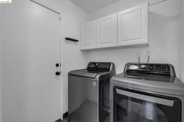 a kitchen with stainless steel appliances granite countertop a sink a stove and a wooden floor