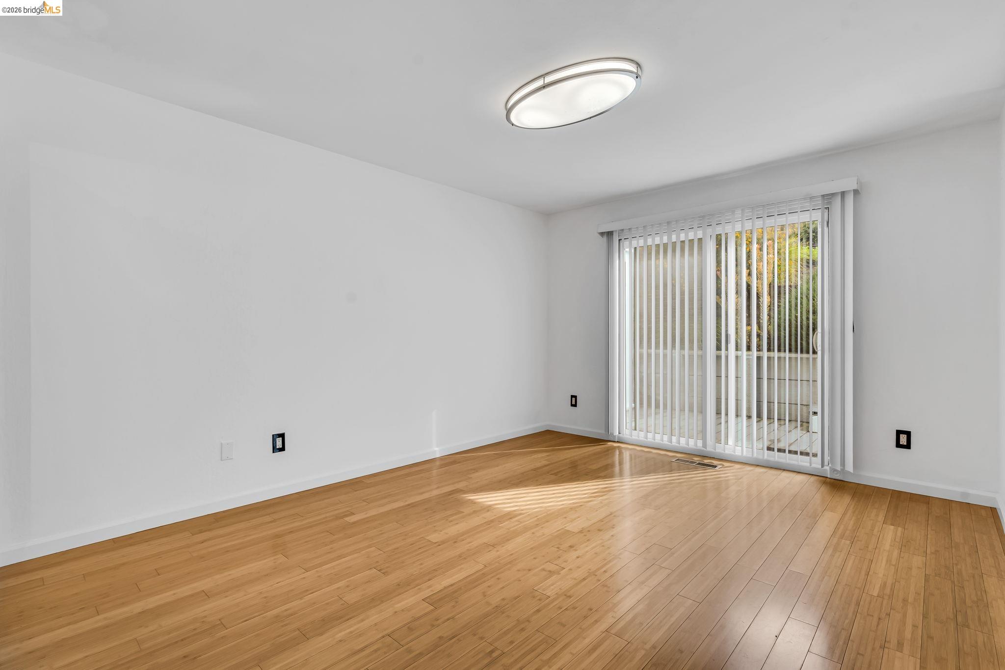 909 Halite Way Antioch, CA 94509 - Photo 15 of 52 a view of an empty room with wooden floor and a window