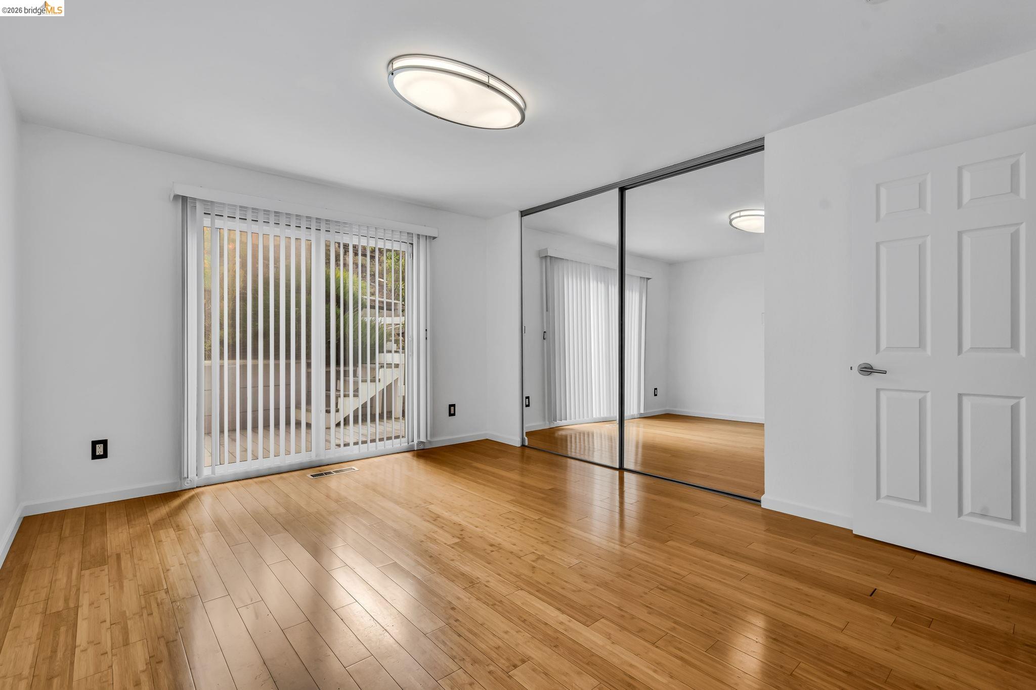 909 Halite Way Antioch, CA 94509 - Photo 18 of 52 a view of an empty room with wooden floor and a window