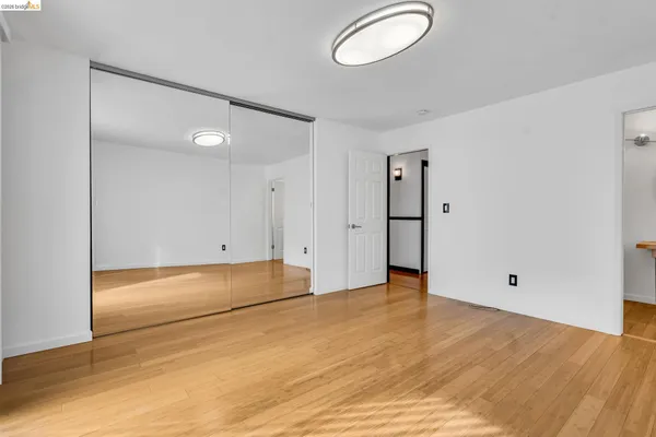 a kitchen that has a lot of cabinets and wooden floor