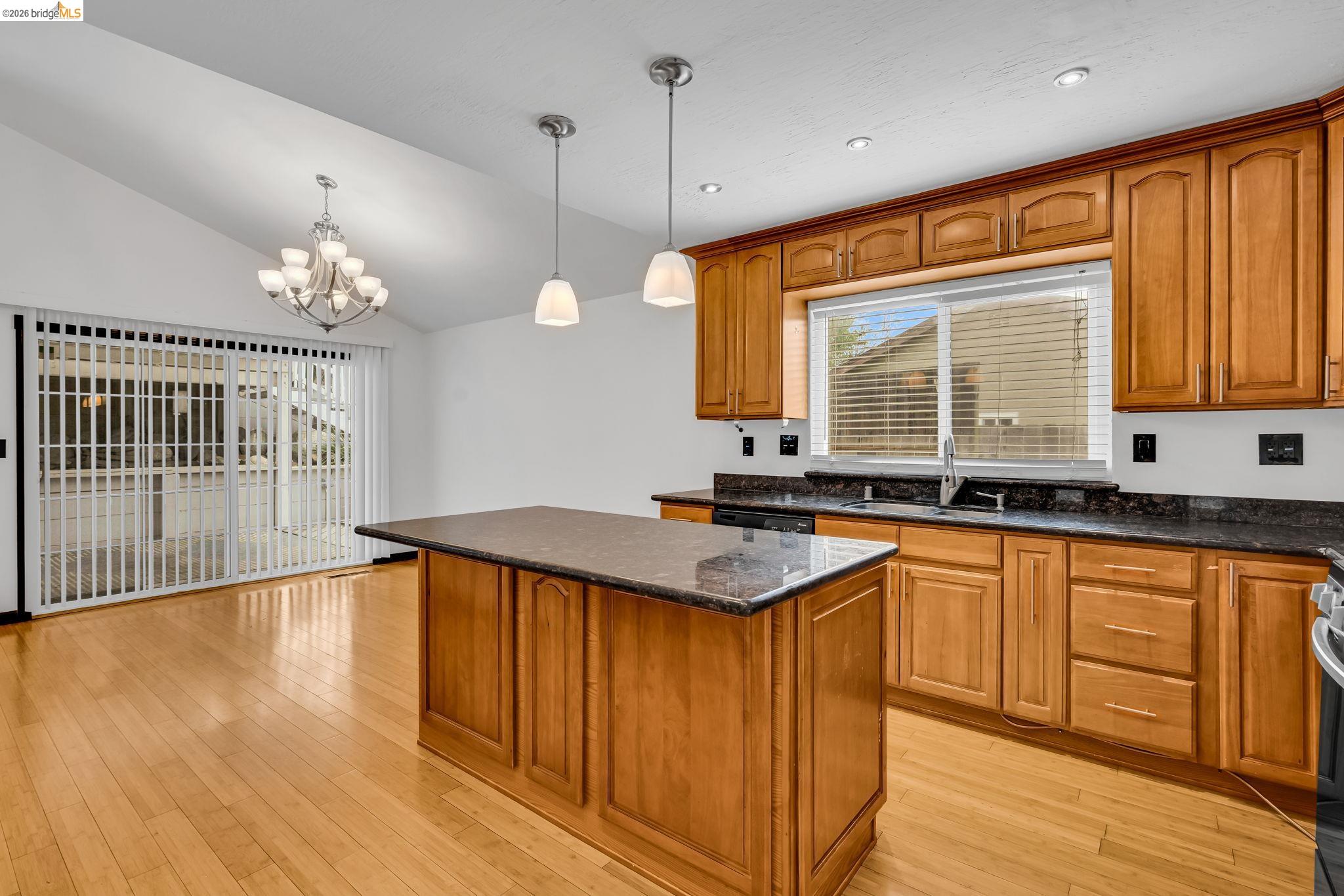 909 Halite Way Antioch, CA 94509 - Photo 28 of 52 a kitchen with stainless steel appliances granite countertop a stove a sink dishwasher a refrigerator and a dining table with wooden floor