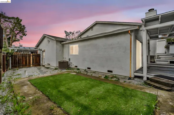a backyard of a house with table and chairs