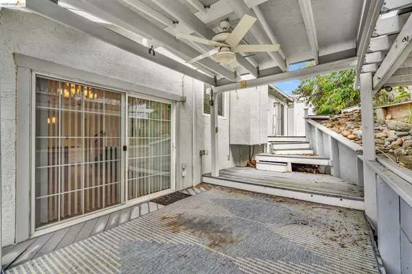 a view of a chair and table in the backyard