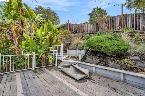 a view of backyard with deck and seating area