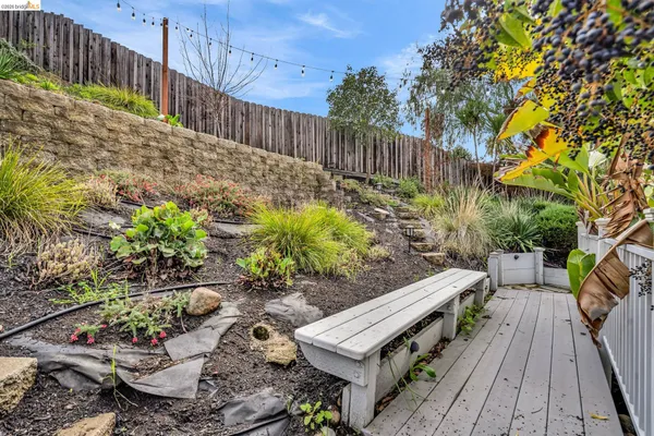 a view of a patio with table and chairs with wooden floor and fence