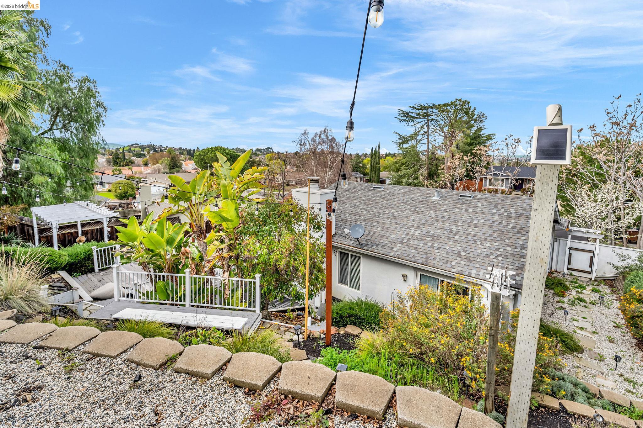 909 Halite Way Antioch, CA 94509 - Photo 48 of 52 Back of property featuring a shingled roof, stucco siding, and a wooden deck