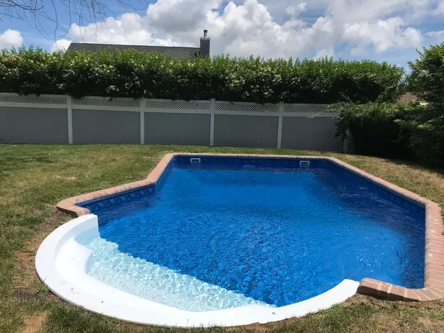 a view of swimming pool with a yard