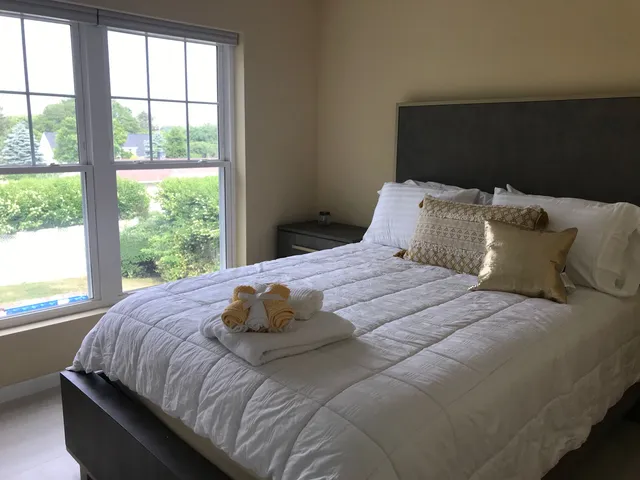 a bedroom with a bed and a window