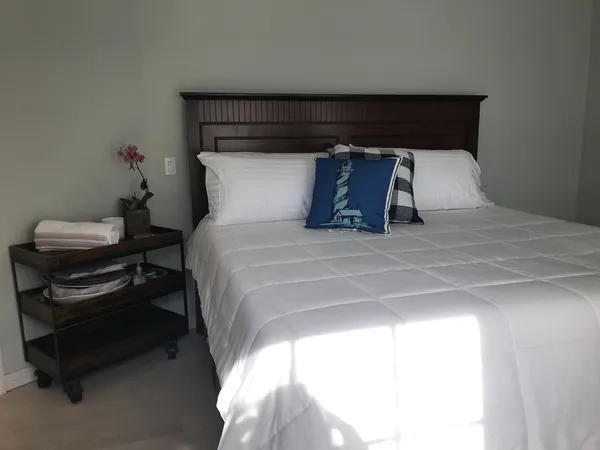 a large bed sitting in a bedroom next to a window