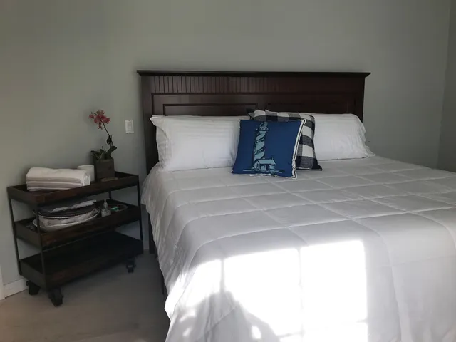 a large bed sitting in a bedroom next to a window