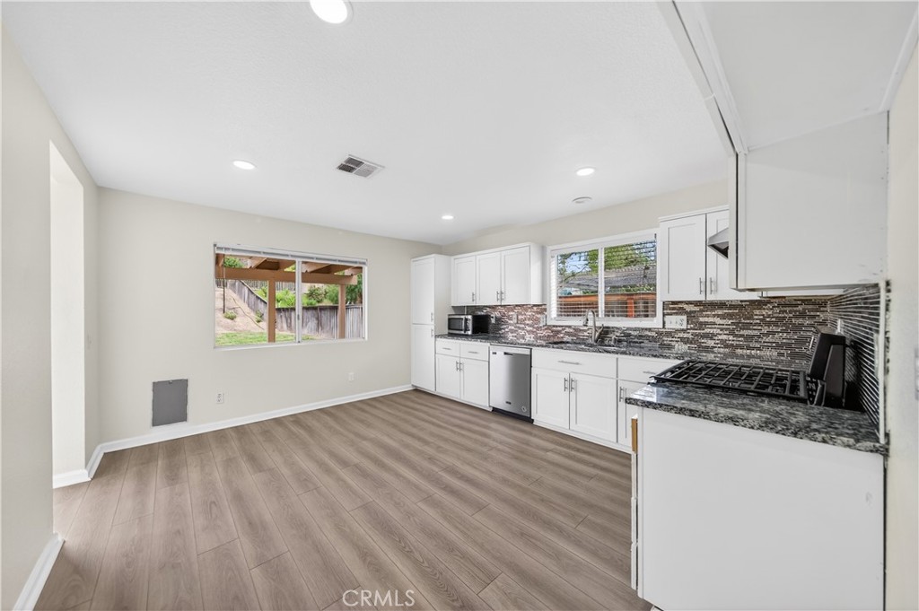 43425 Corte Logrono Temecula, CA 92592 - Photo 15 of 49 a kitchen with a refrigerator and white cabinets