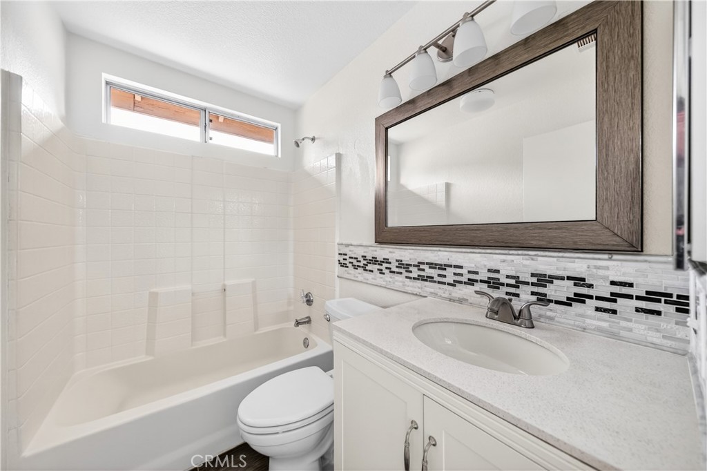 43425 Corte Logrono Temecula, CA 92592 - Photo 26 of 49 a bathroom with a sink a toilet and a mirror