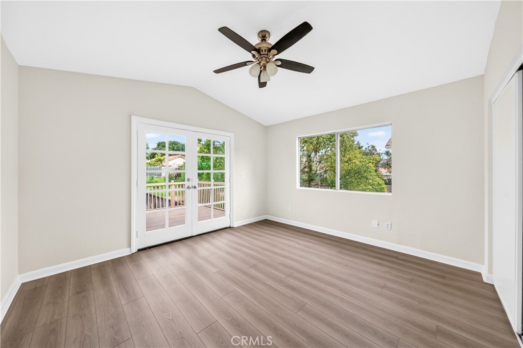 43425 Corte Logrono Temecula, CA 92592 - Photo 27 of 49 an empty room with wooden floor chandelier fan and windows