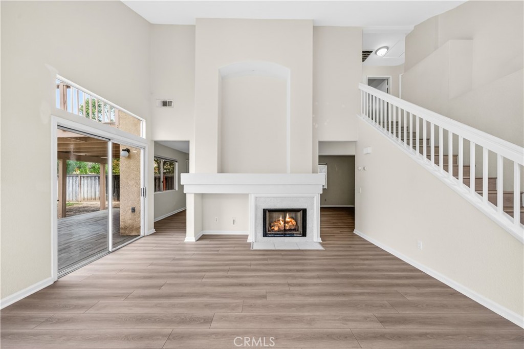 43425 Corte Logrono Temecula, CA 92592 - Photo 7 of 49 a view of a livingroom with wooden floor and a fireplace