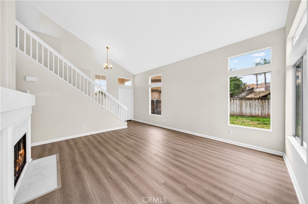 43425 Corte Logrono Temecula, CA 92592 - Photo 9 of 49 a view of an empty room with wooden floor and a window