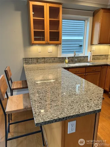 a view of a kitchen with granite countertop