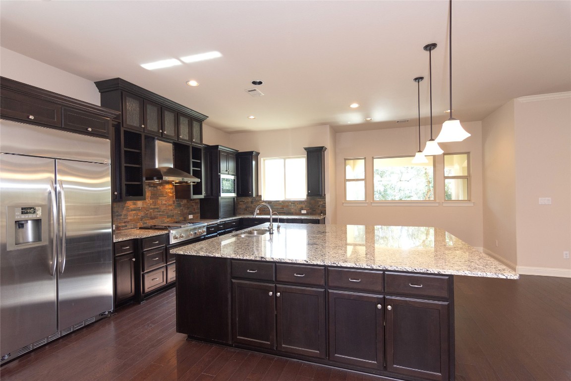 316 Chadwick Drive Georgetown, TX 78628 - Photo 11 of 39 a kitchen with granite countertop a sink and stainless steel appliances