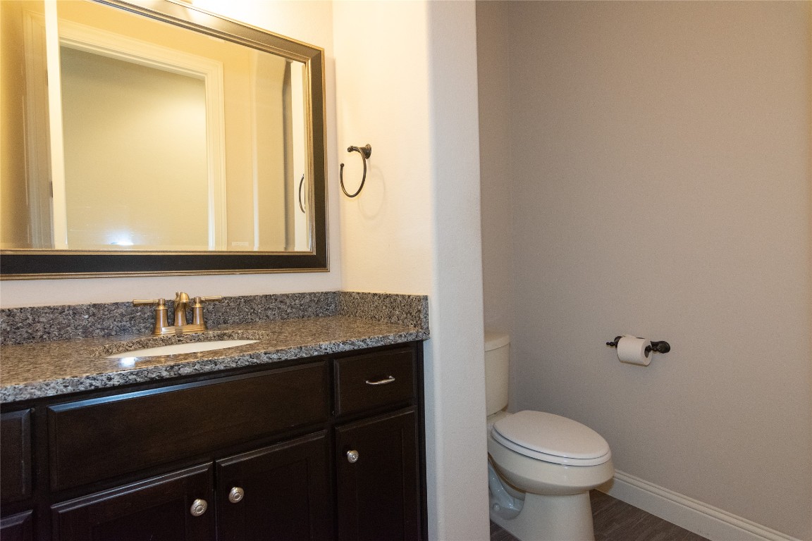 316 Chadwick Drive Georgetown, TX 78628 - Photo 14 of 39 a bathroom with a granite countertop sink toilet and mirror