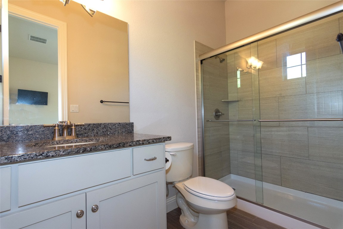 316 Chadwick Drive Georgetown, TX 78628 - Photo 35 of 39 a bathroom with a granite countertop sink toilet and shower