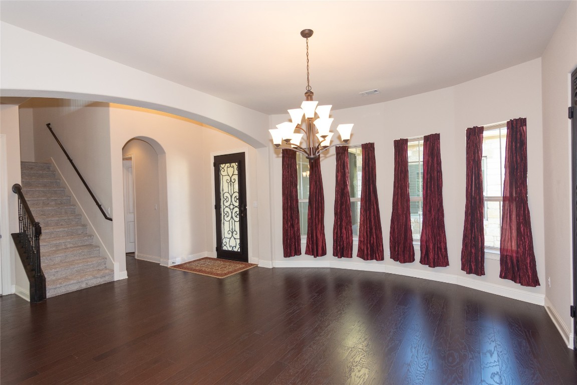 316 Chadwick Drive Georgetown, TX 78628 - Photo 5 of 39 a view of a room with wooden floor staircase and a kitchen