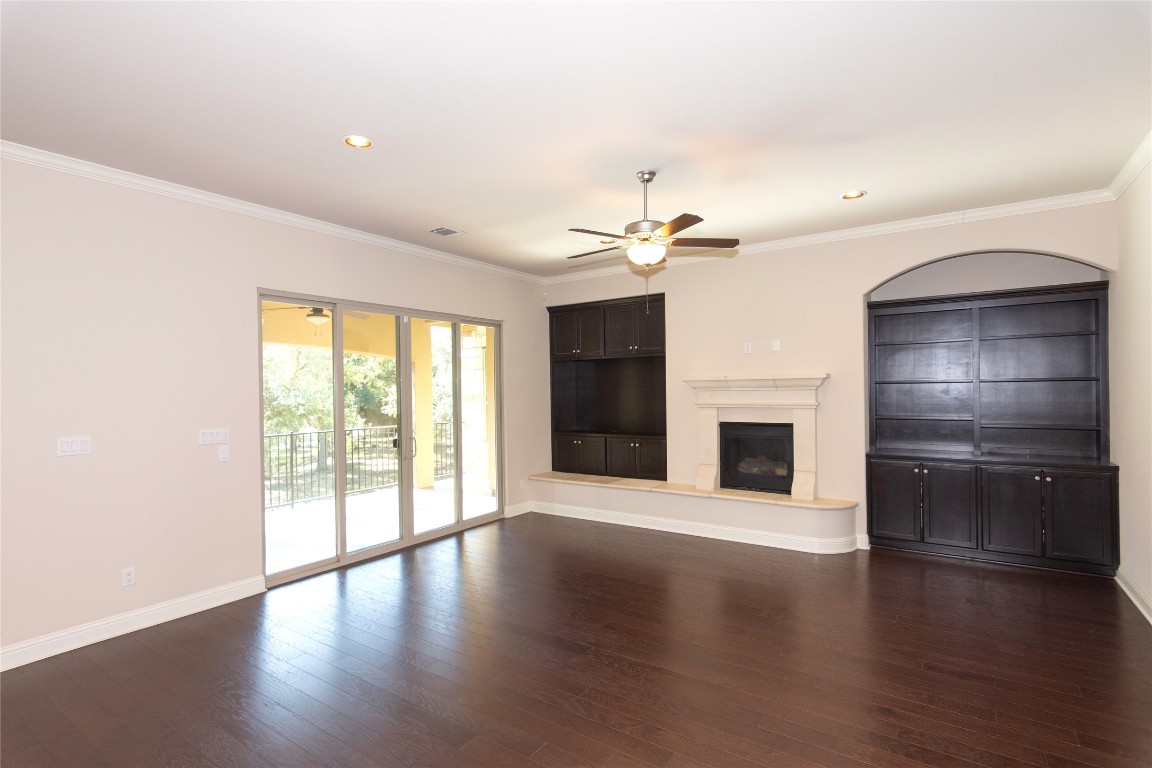 316 Chadwick Drive Georgetown, TX 78628 - Photo 7 of 39 an empty room with wooden floor fireplace and windows