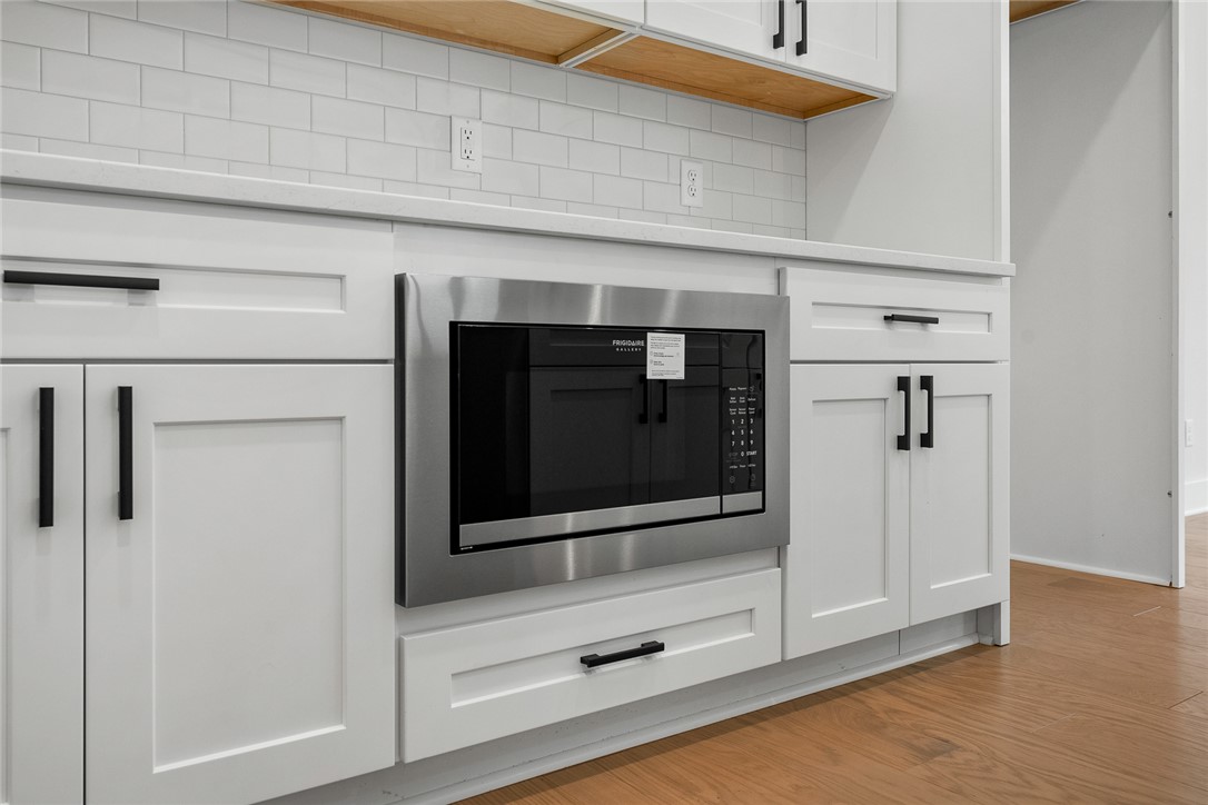 100 Garden Gate Drive Anderson, SC 29621 - Photo 17 of 43 This modern kitchen features crisp white cabinetry and a built-in stainless steel microwave.