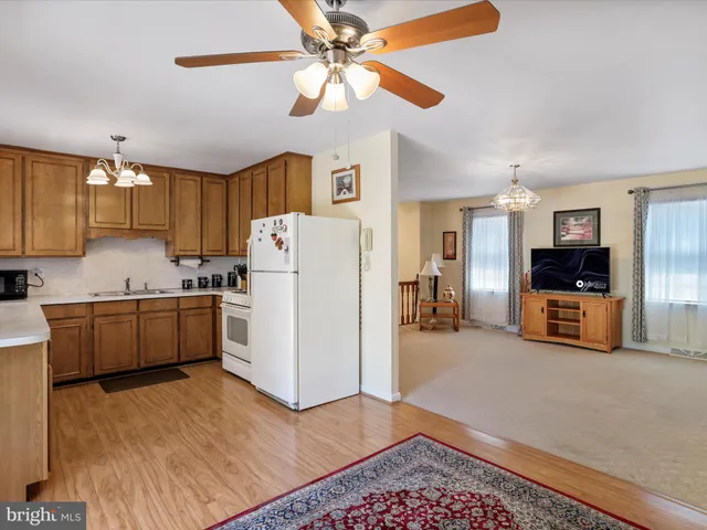 a kitchen with a refrigerator a sink and cabinets