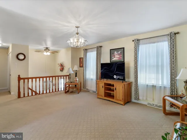 a kitchen with stainless steel appliances granite countertop a refrigerator a oven a sink dishwasher and white cabinets with wooden floor