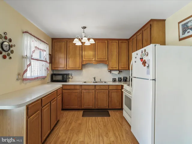 a view of a kitchen with wooden floor and window