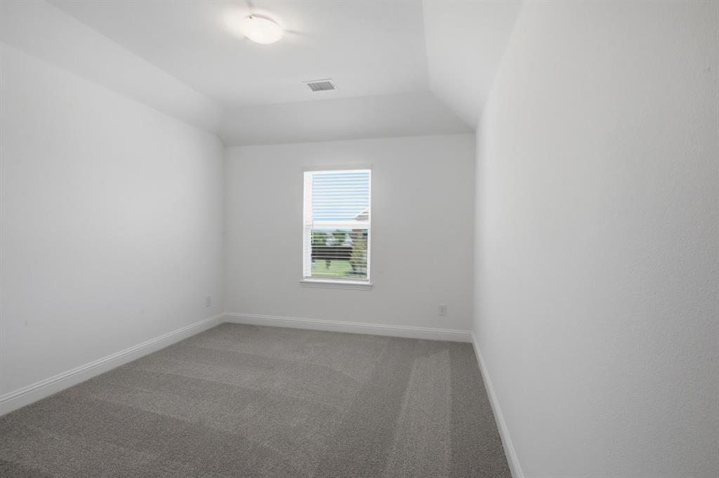 2911 Hanscom Street Forney, TX 75126 - Photo 9 of 40 Carpeted room featuring a single window, white window blinds, and white baseboards