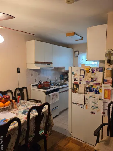 a kitchen with refrigerator and stove