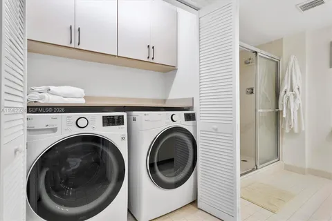 a view of a balcony with chairs and a potted plant