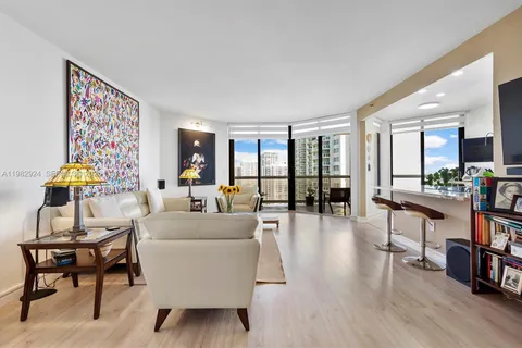 a living room with furniture and a floor to ceiling window