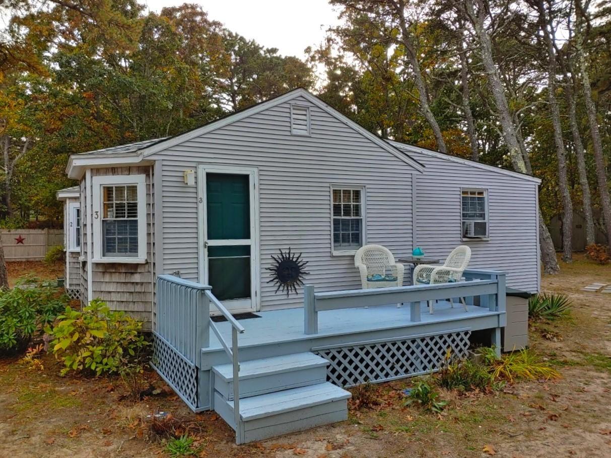 a view of a house with a chairs in patio