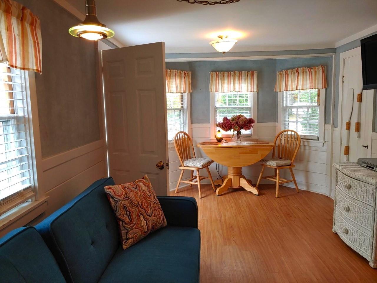 633 Route 6, Unit 3 Wellfleet, MA 02667 - Photo 2 of 9 a living room with furniture and a window