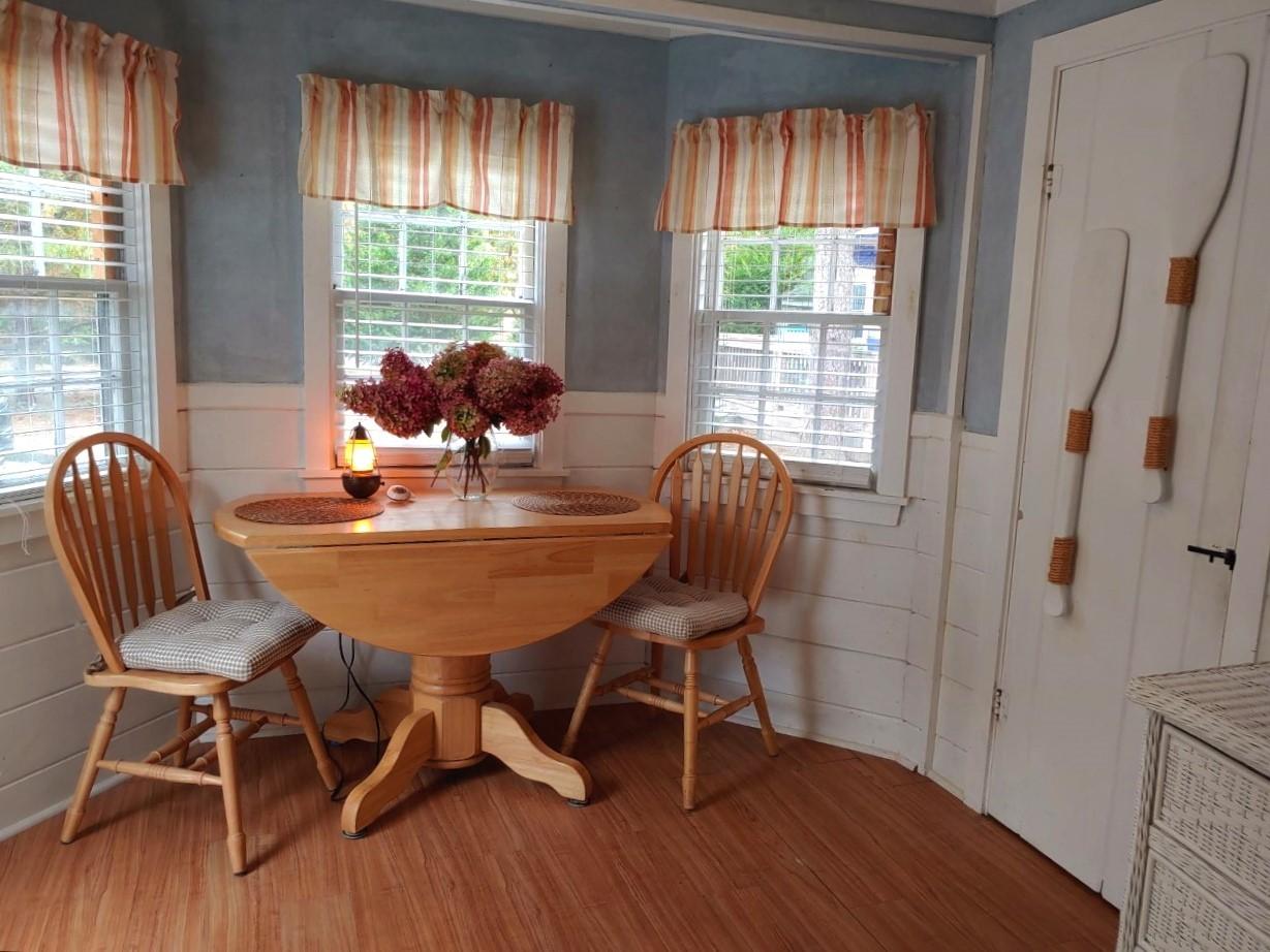 633 Route 6, Unit 3 Wellfleet, MA 02667 - Photo 4 of 9 a dining room with furniture and wooden floor
