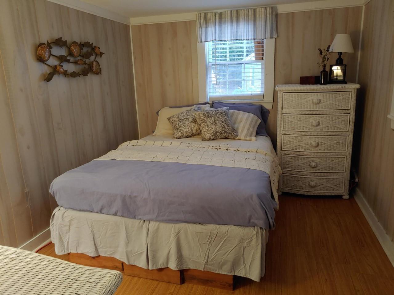 633 Route 6, Unit 3 Wellfleet, MA 02667 - Photo 8 of 9 a bedroom with a bed and a dresser
